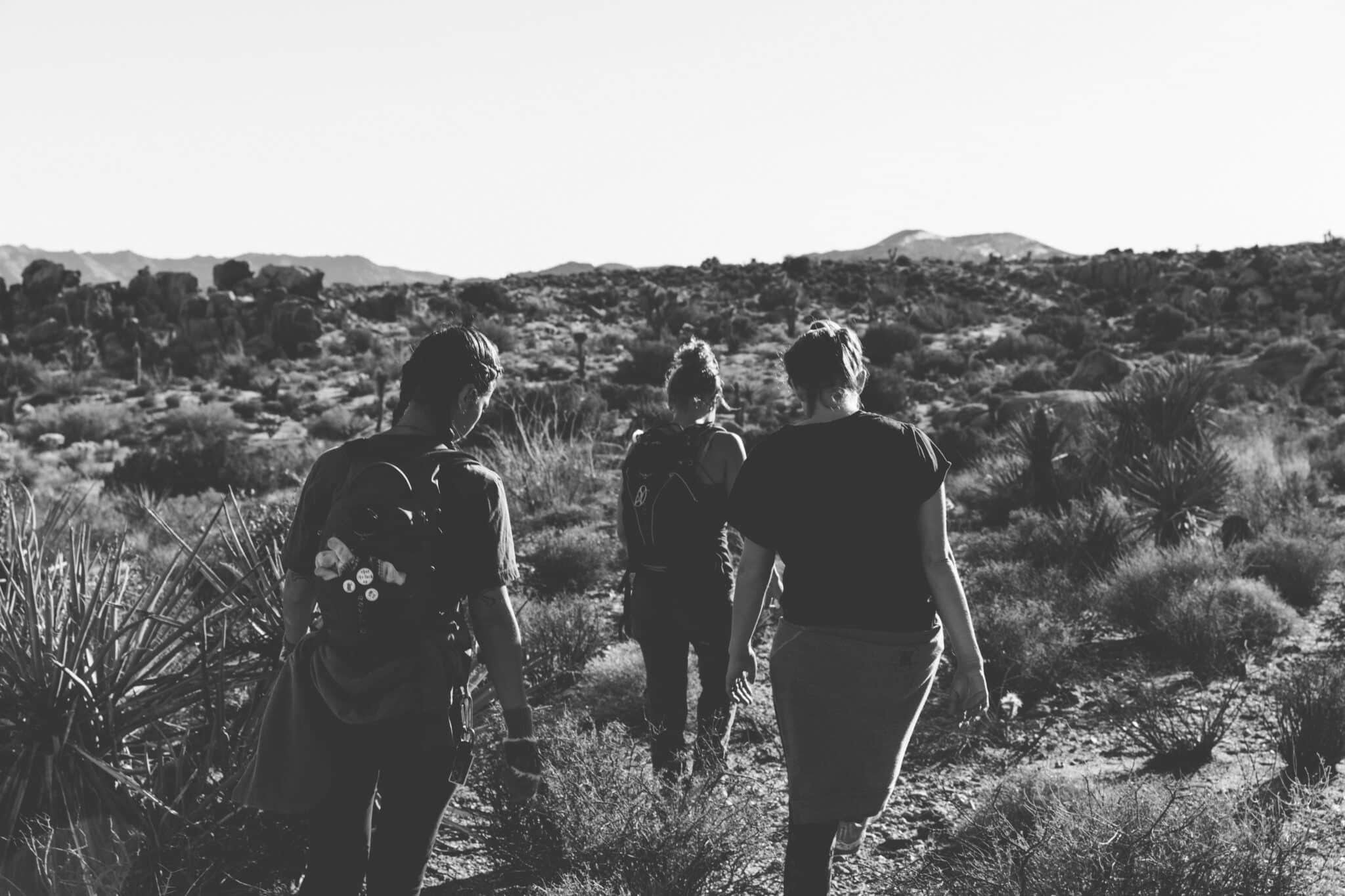 a group of people walking on a dirt path | Photo by roya ann miller on Unsplash