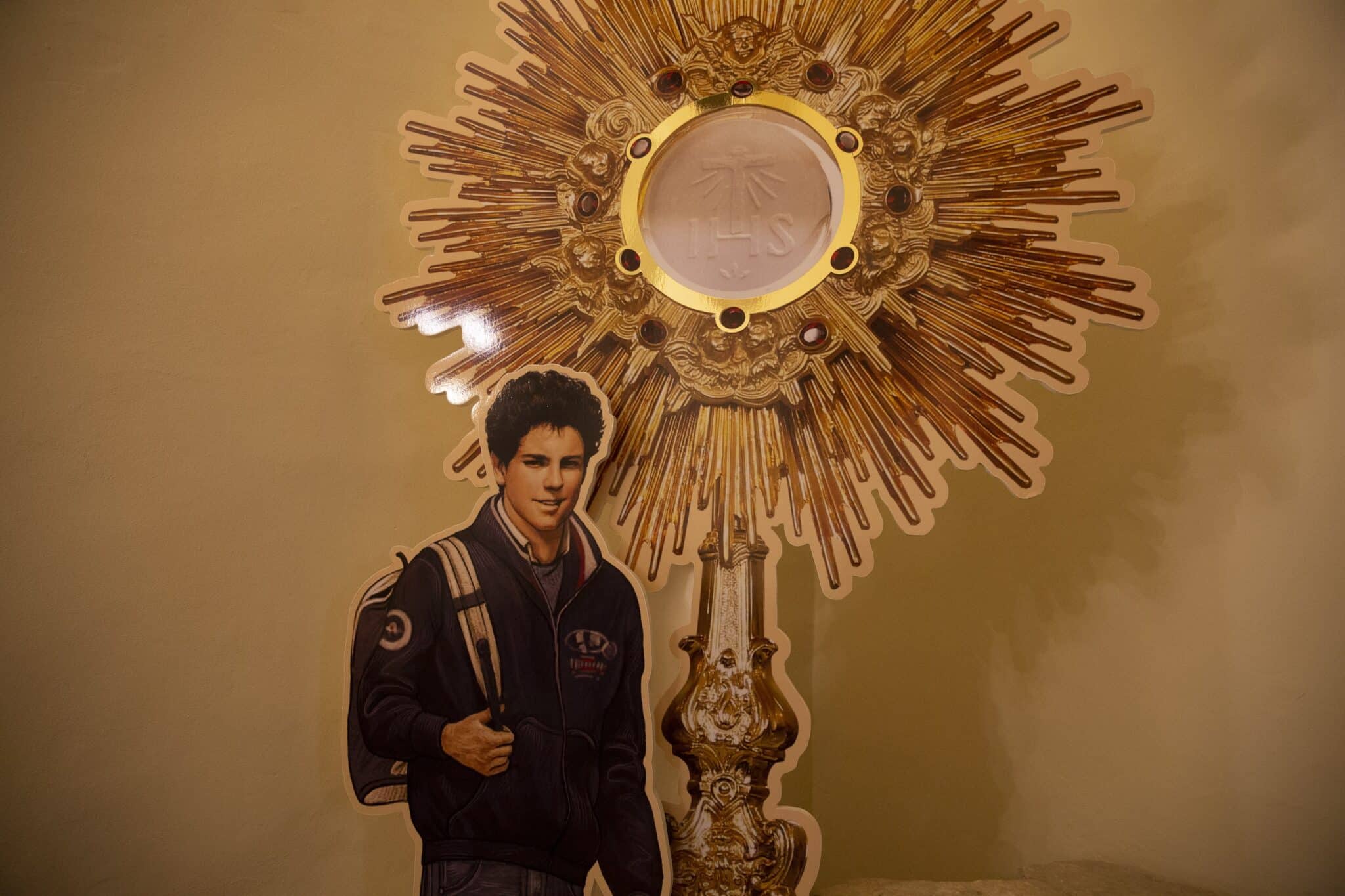 A display showing Carlo Acutis and a monstrance is seen near his tomb at the Church of Santa Maria Maggiore in Assisi, Italy, Oct. 3, 2020. The Italian teen, who had a great love for the Eucharist, will be beatified Oct. 10 in Assisi. (CNS photo/Paul Haring)