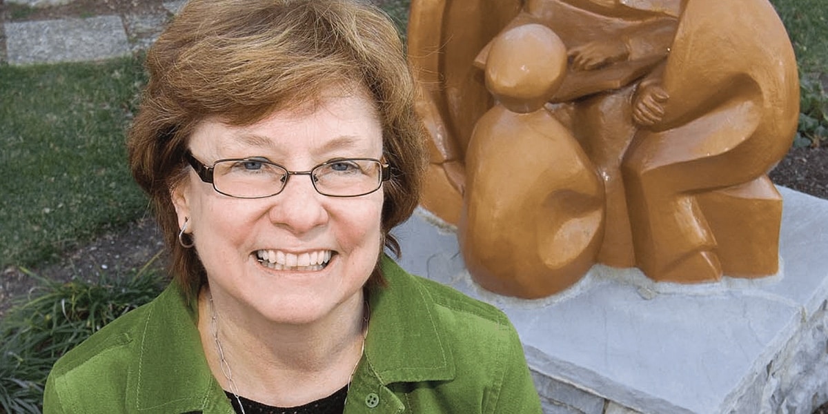 Dr. Buffy Barkley next to a statue of St. Elizabeth Ann Seton