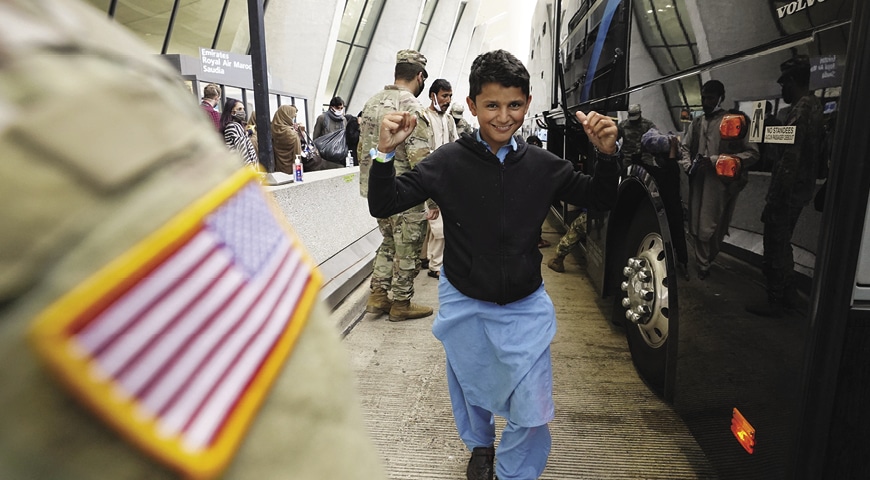 Afghan boy raises his arms in triumph