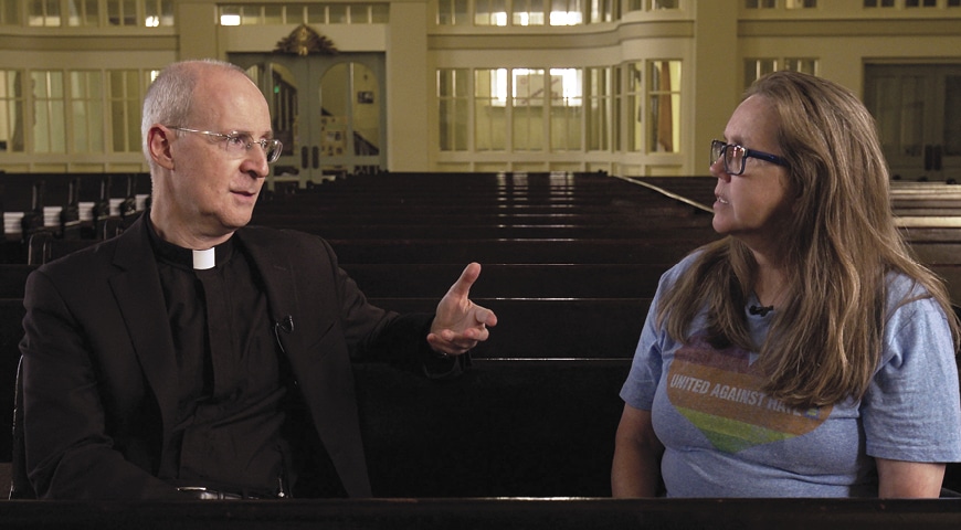 Father Jim Martin, SJ, talks to a parent