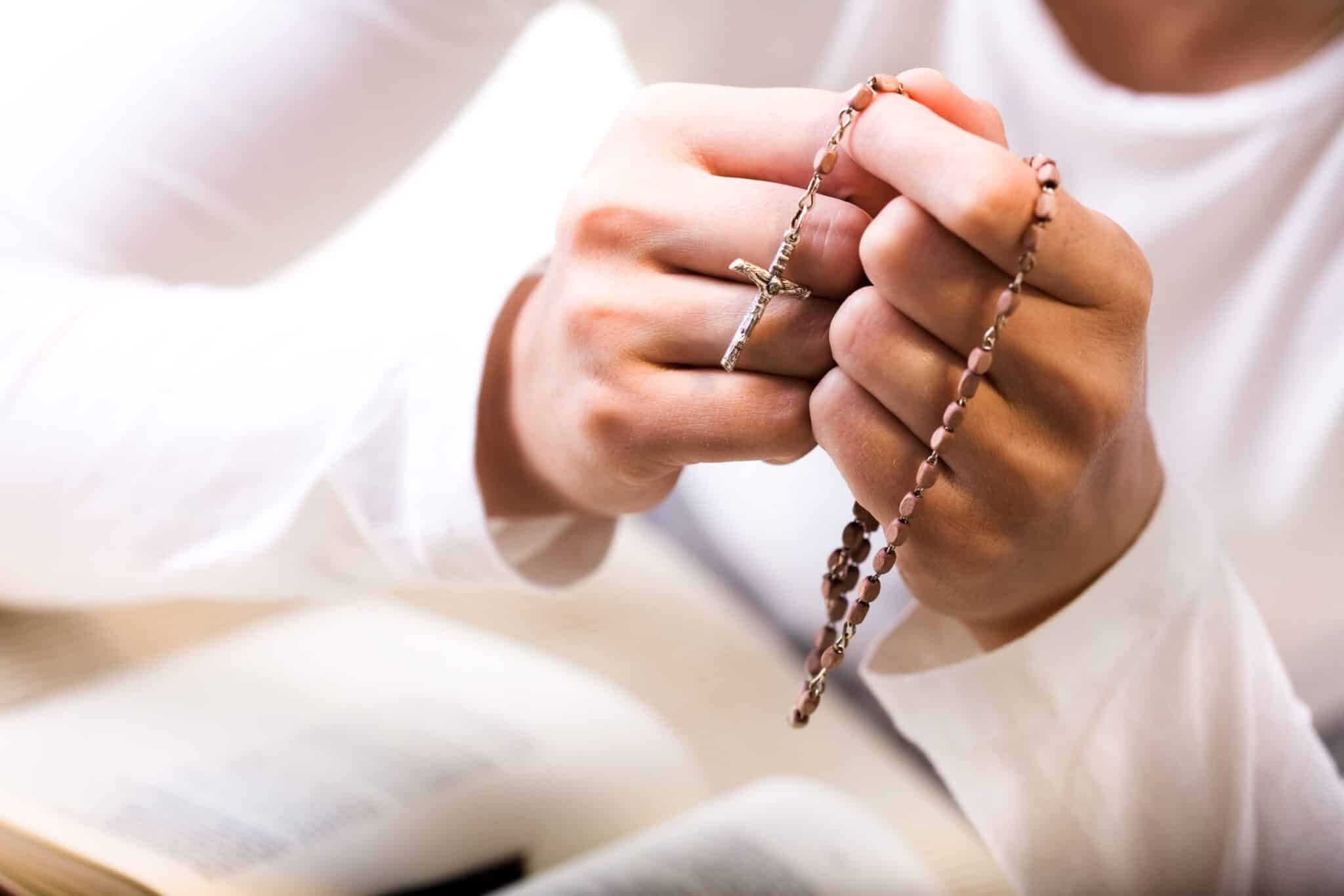 Woman praying rosary