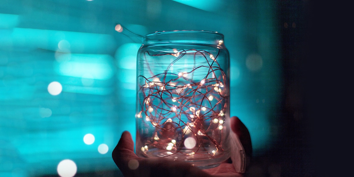 hand holding jars with lights