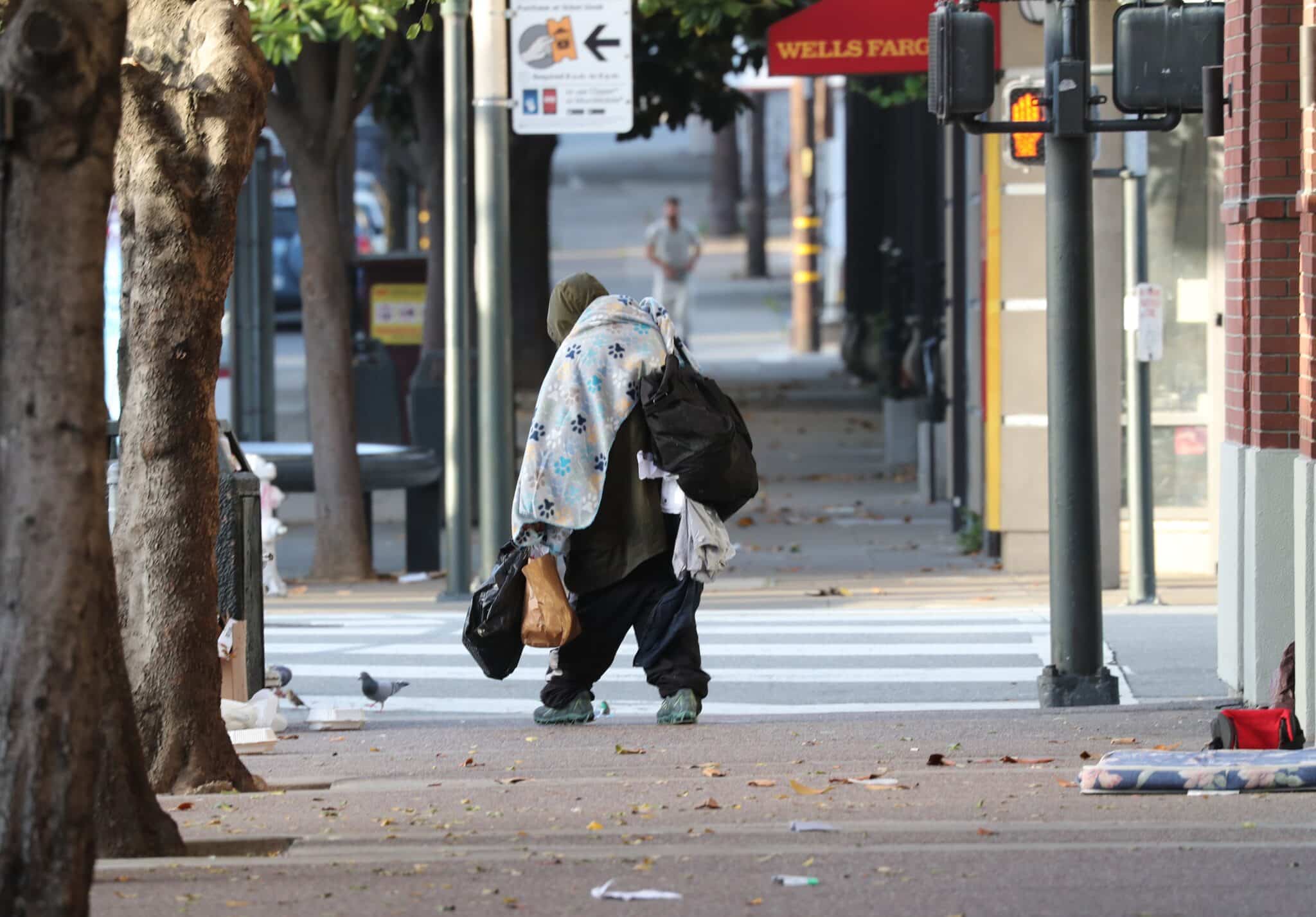 A homeless man carries his belongings along a street in San Francisco May 19, 2024. The needs of the homeless and other vulnerable groups in the U.S. have been among the concerns of the U.S. bishops' Catholic Campaign for Human Development as it has provided grants, through an application process, to groups that address societal issues. Other target projects of CCHD, founded in 1970, have included voter registration, credit unions, job training programs, cooperatives and nonprofit housing corporations.