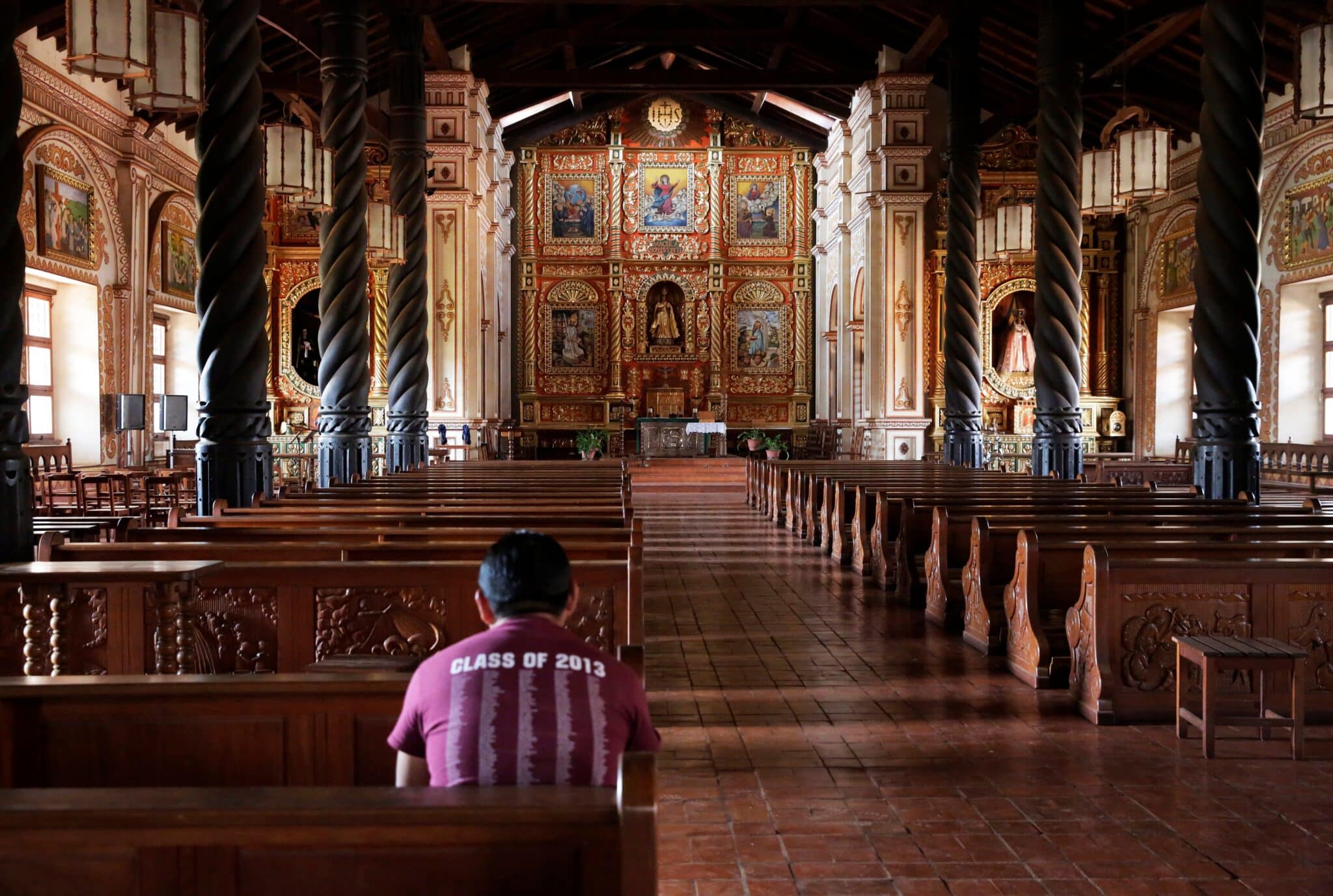 A devotee is seen in Immaculate Conception Cathedral in Concepcion, Bolivia, one of many historic Jesuit missionary sites within the country declared a World Heritage Site in 2019. (OSV News photo/David Mercado, Reuters)
