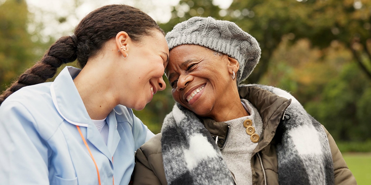 two woman of different age enjoying a conversation in a park