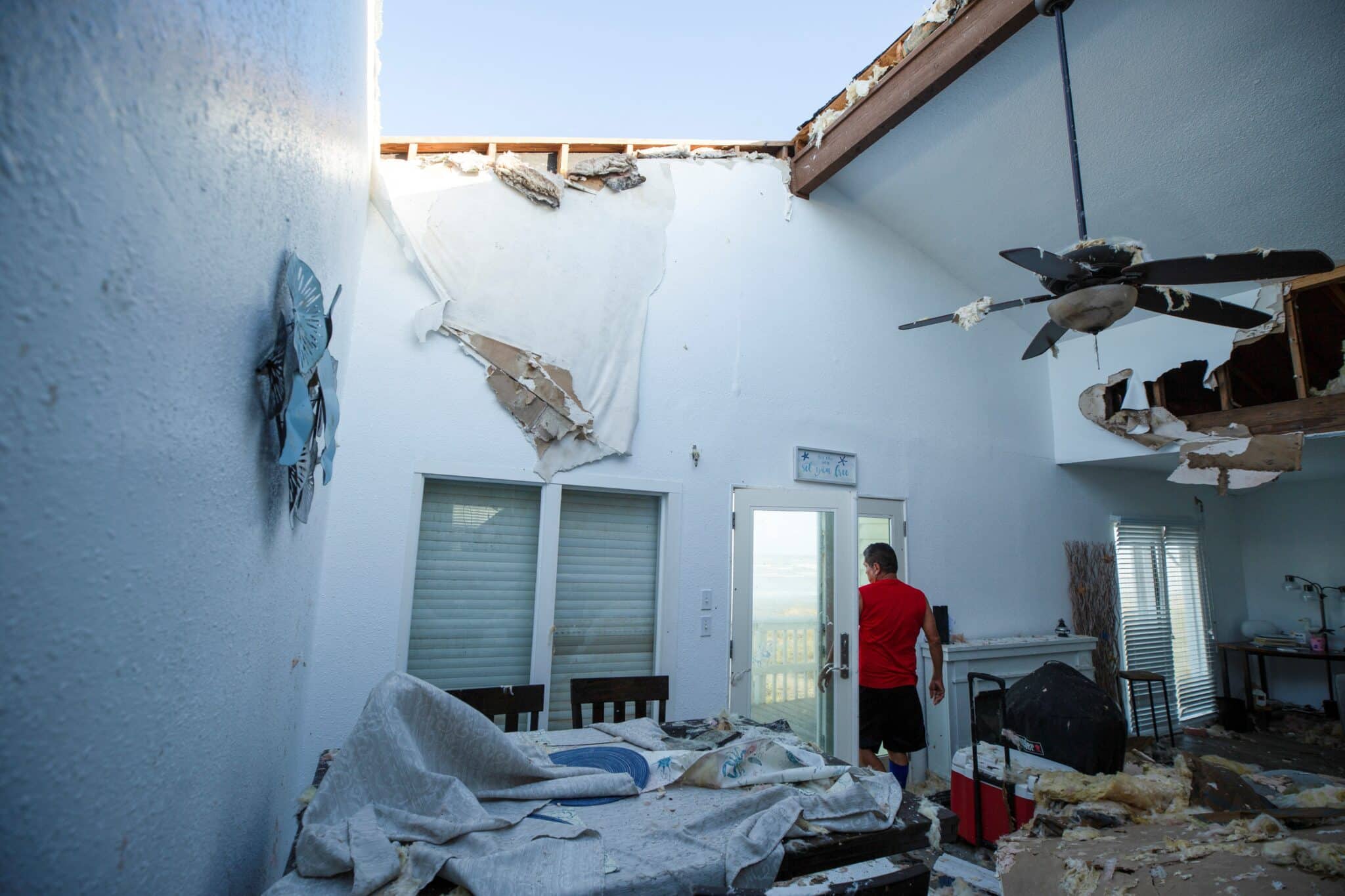 A contractor surveys a Dallas-based client's home for structure damage after Hurricane Beryl moved through the area in Galveston, Texas, July 8, 2024. Beryl slammed into Texas early that morning, knocking out power to nearly 3 million homes and businesses, unleashing heavy rain and causing multiple deaths as it moved east and later weakened to a tropical depression, the National Hurricane Center said.