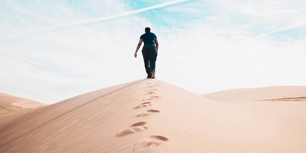 man walking in the desert