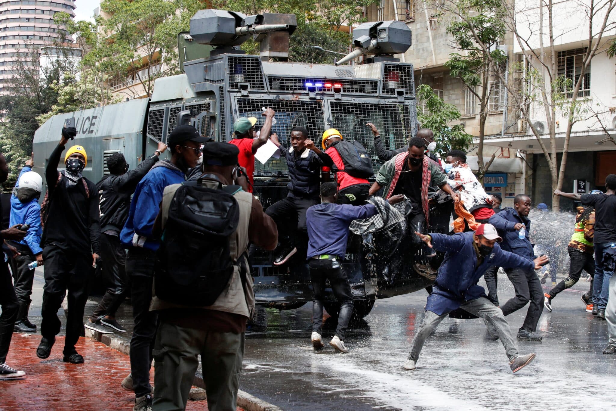 Demonstrators try to obstruct a police vehicle as police use water cannons to disperse protesters during a demonstration in Nairobi June 25, 2024, against Kenya's proposed finance bill to raise taxes. After Parliament passed the measure, it was sent to Kenyan President William Ruto for his signature or other action. In the face of chaos, Ruto rejected the bill June 26. (OSV News photo/Monicah Mwang, Reuters)