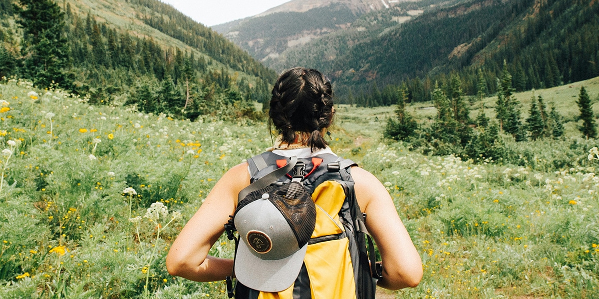 woman hiking in the mountains carrying a backpack