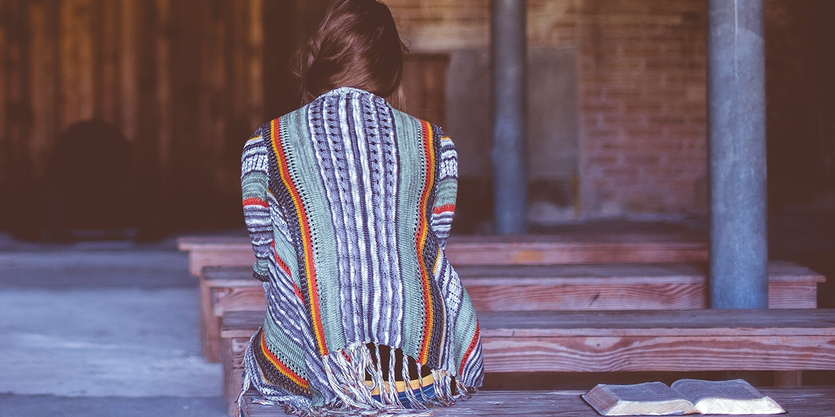 woman praying in a church