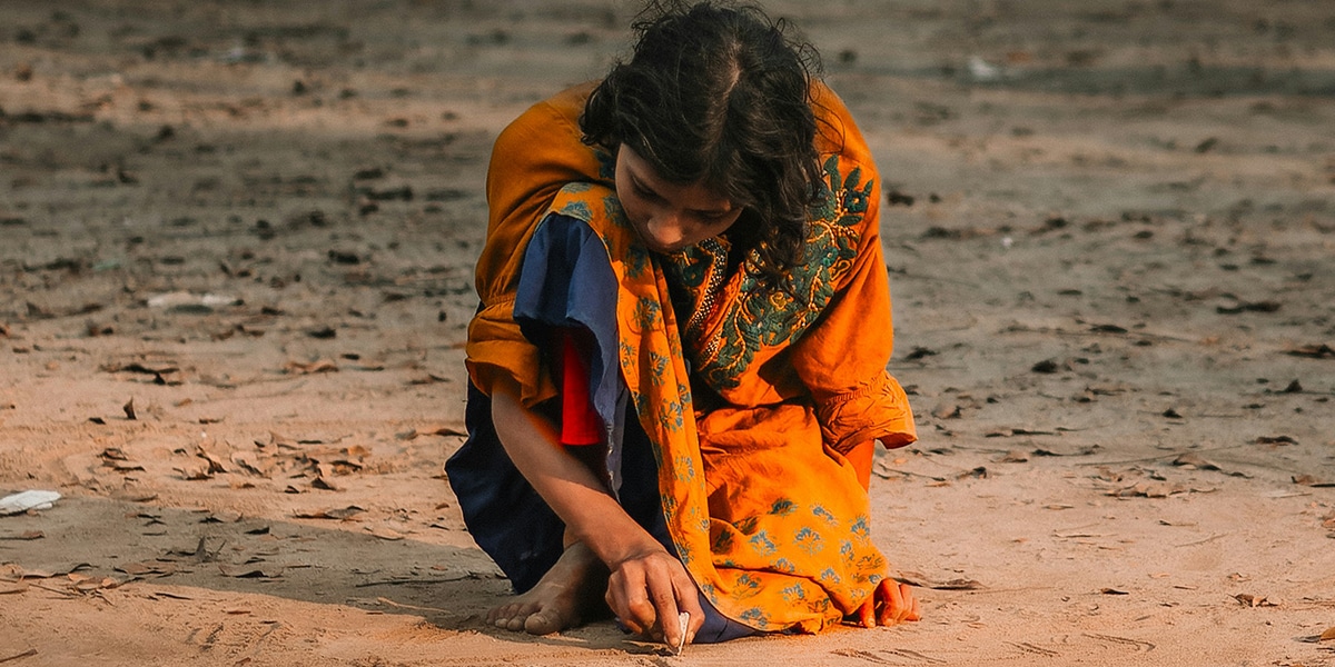 A young poor woman sitting in the street in India