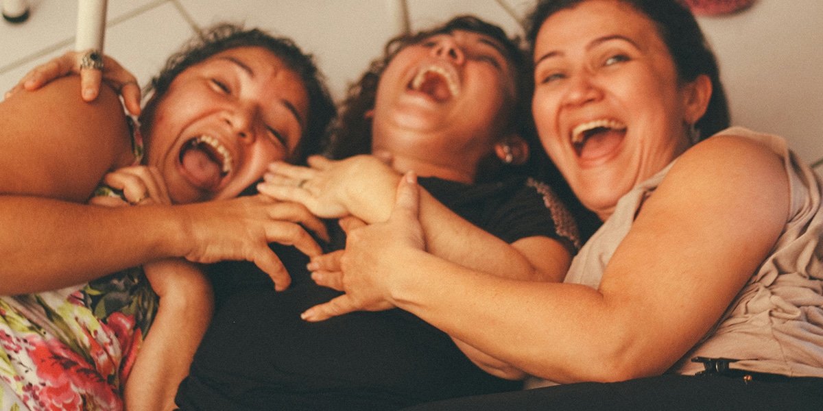 Three women laughing together