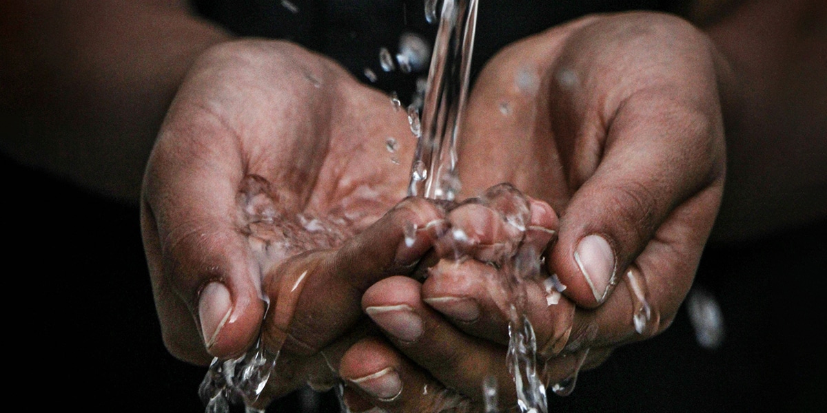 hands folded together collecting clean water