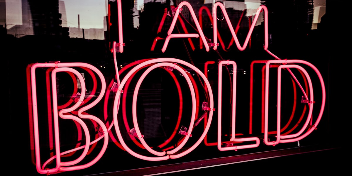 red neon sign saying "I am bold"