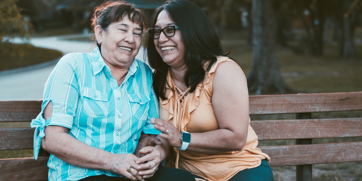 two woman friends enjoying a laugh together