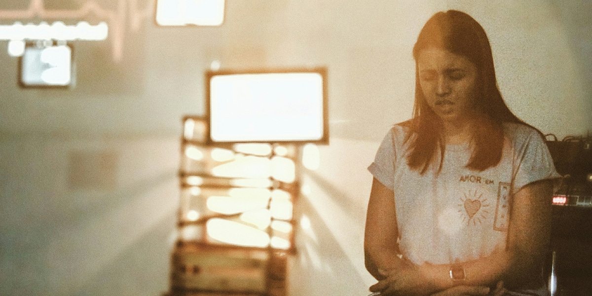 woman praying in a chapel