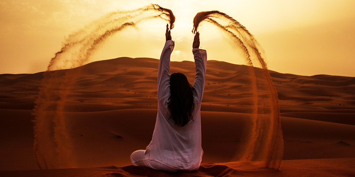 woman through movement creating a circle with sand