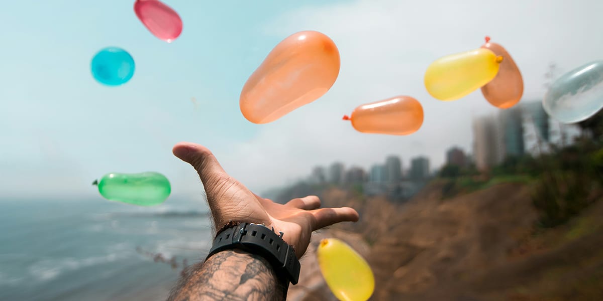 open hand with flying balloons