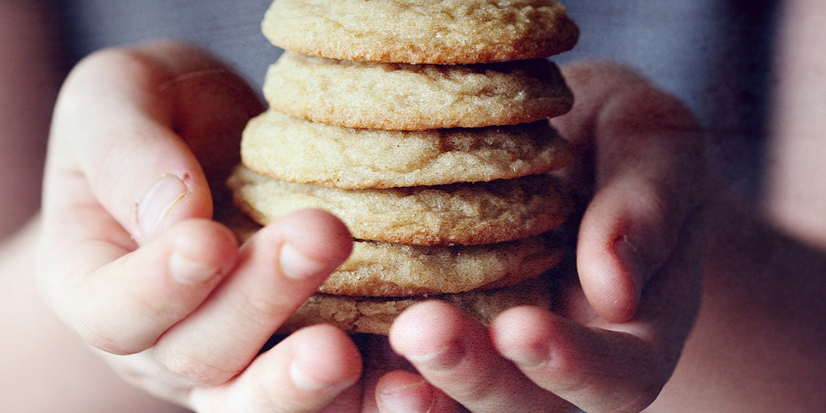 hands holding a pile of cookies