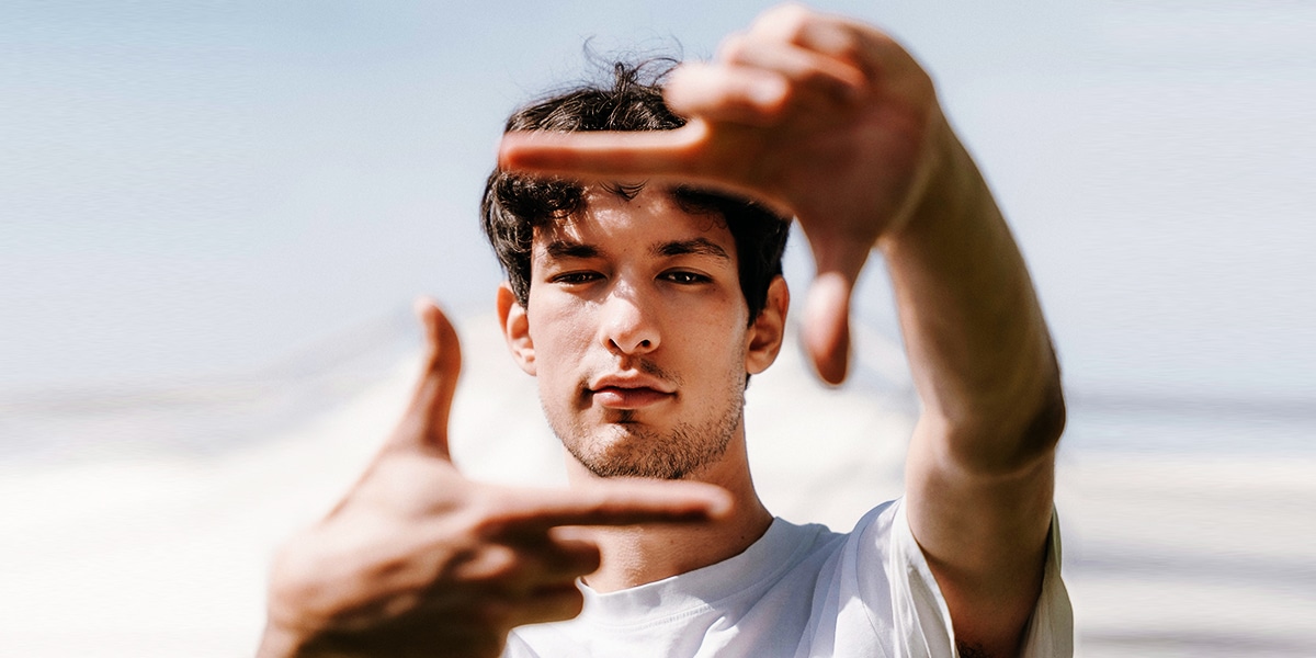 A man forming a picture frame with his hands.