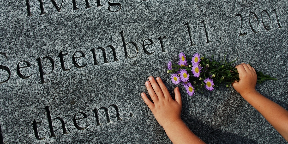 Children hands holding flowers at the 911 memorial