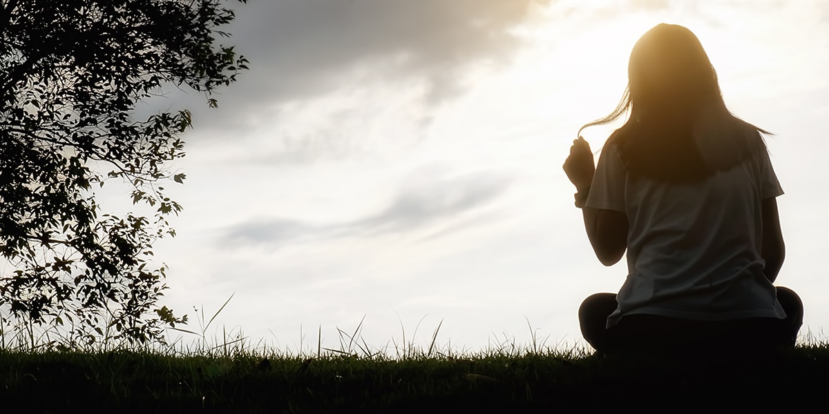 woman sitting in a field in serenity