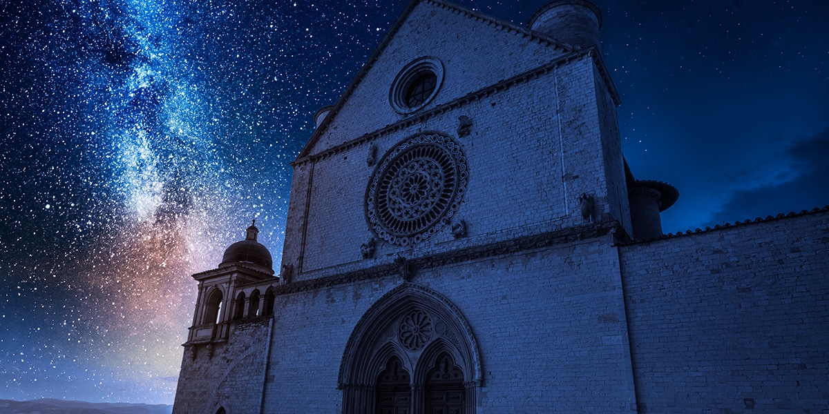 A basilica in Assisi, Italy, at night with stars