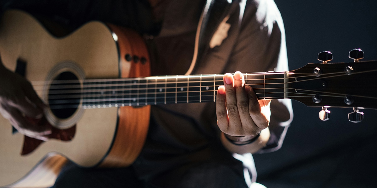 a man is making music with a guitar