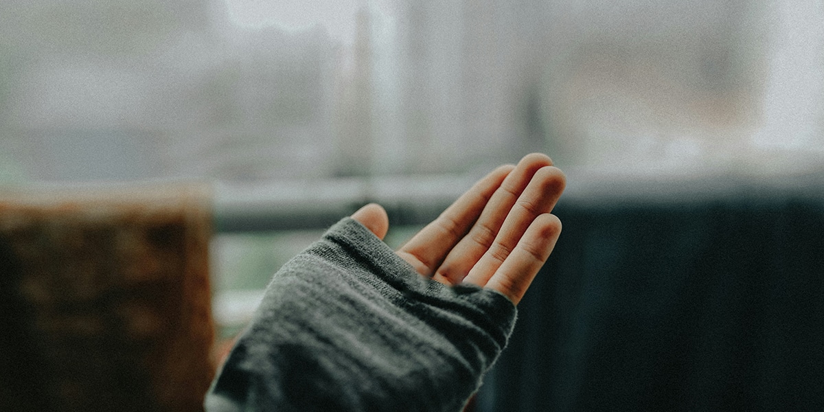 hand with a fingerless glove.