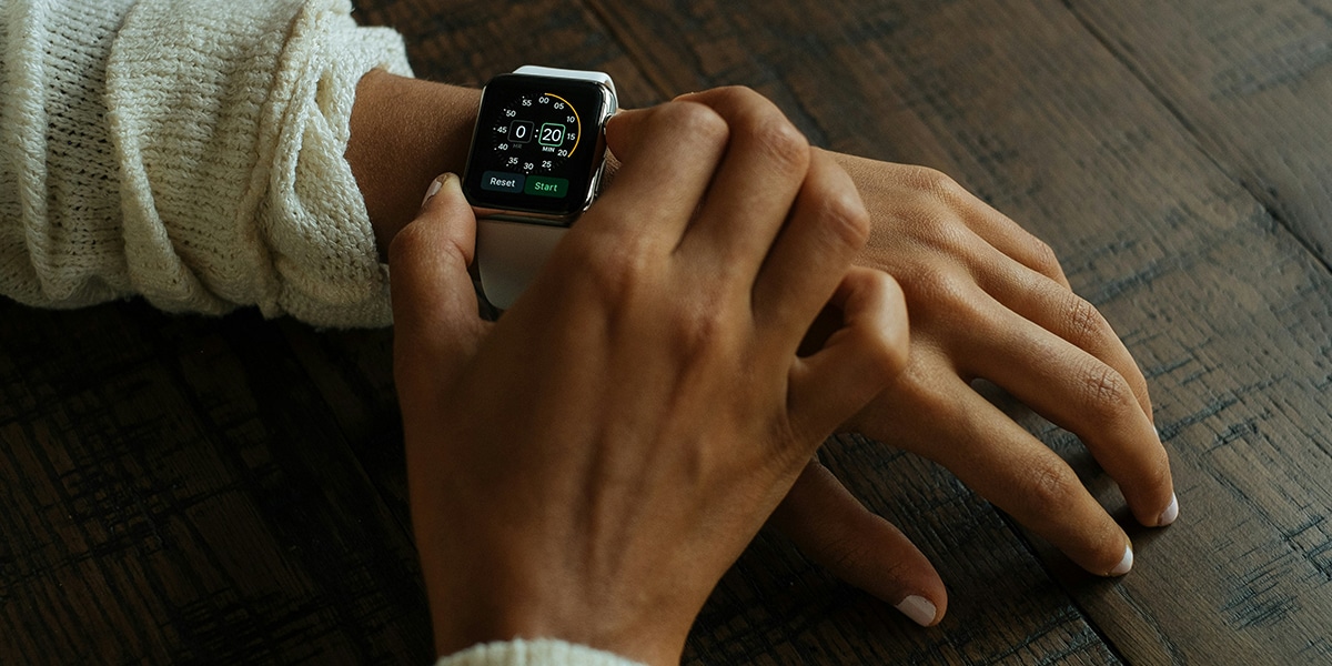 hand setting the time on a watch