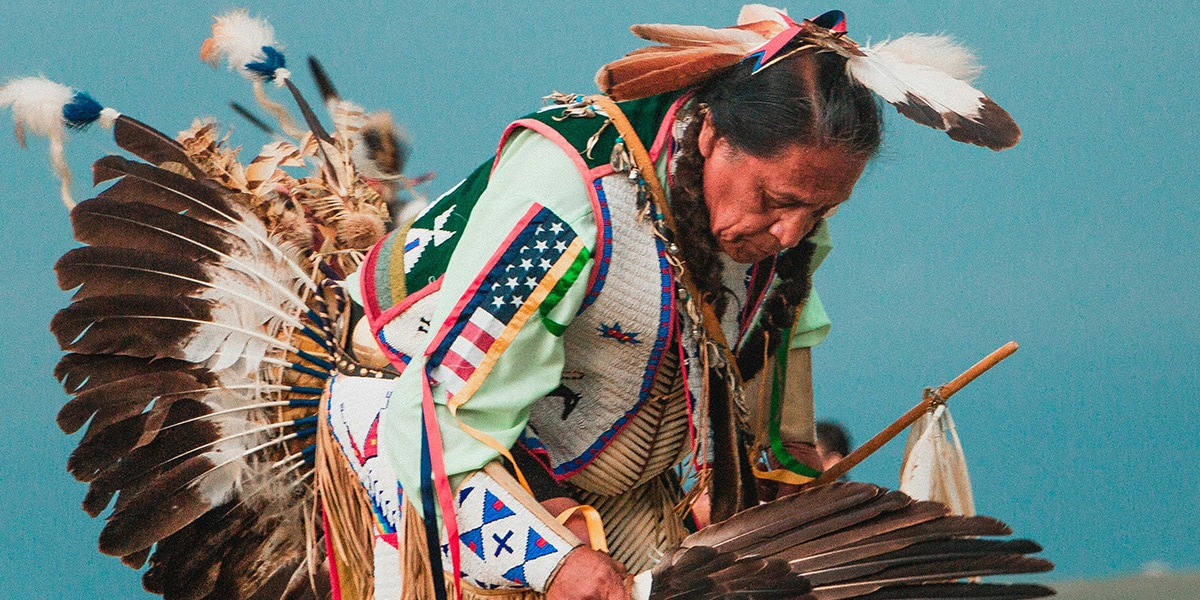 Indigenous man in traditional clothing dancing