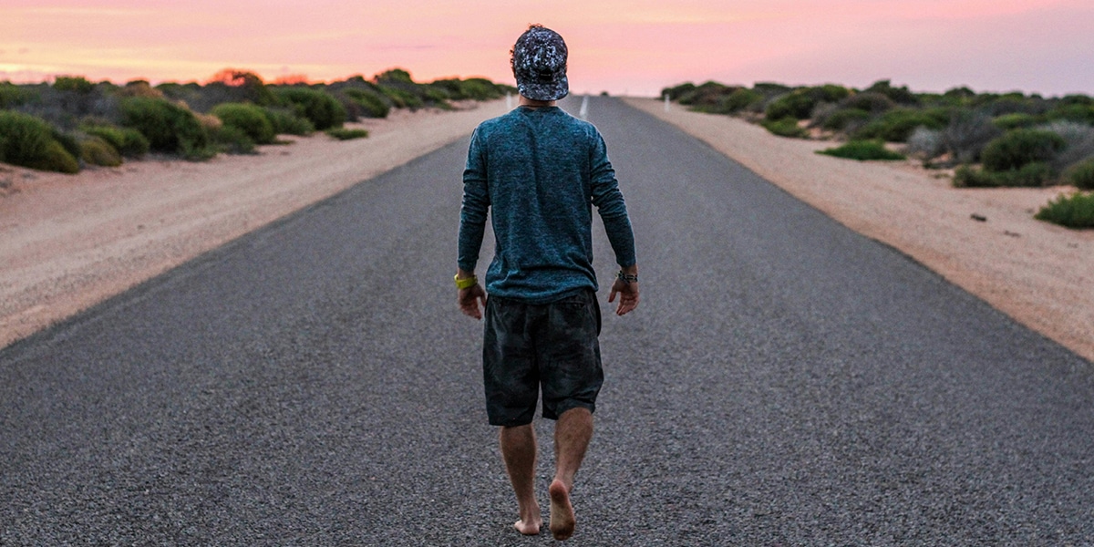 man walking down a road.