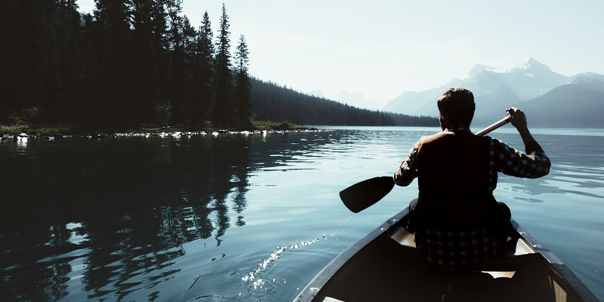 man in a boat floating on water.