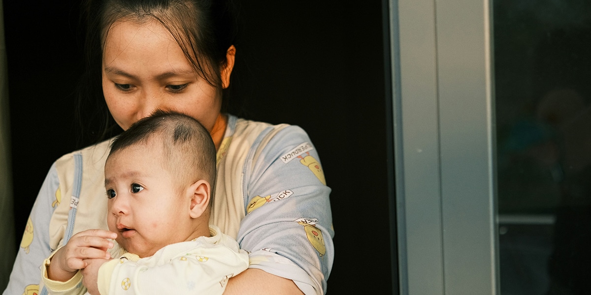 A mother holding her baby in her arms