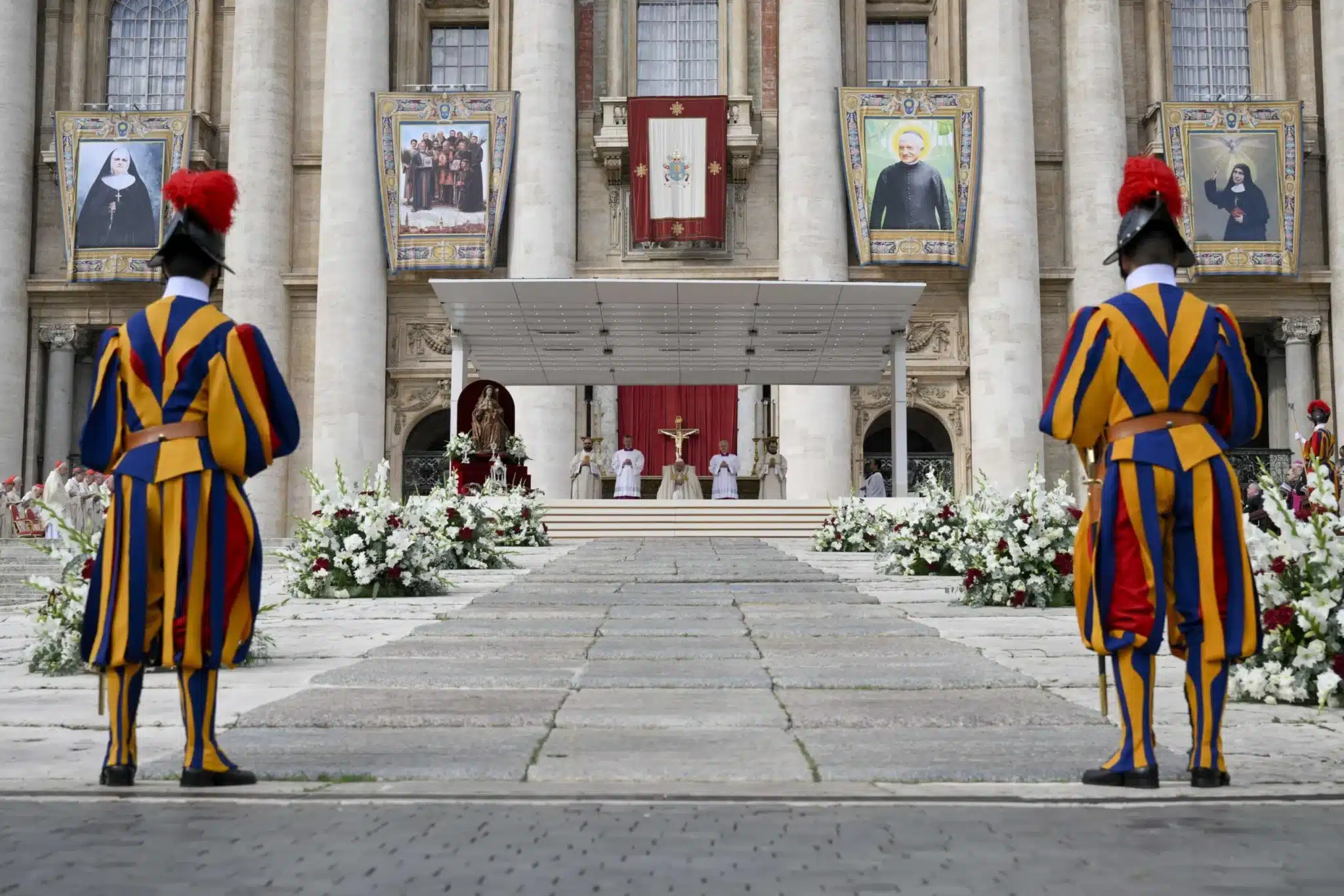 Banners of new saints hang from the facade of St. Peter's Basilica during Mass for the canonization of 14 new saints on World Mission Sunday in St. Peter's Square with Pope Francis at the Vatican Oct. 20, 2024. (CNS photo/Vatican Media)