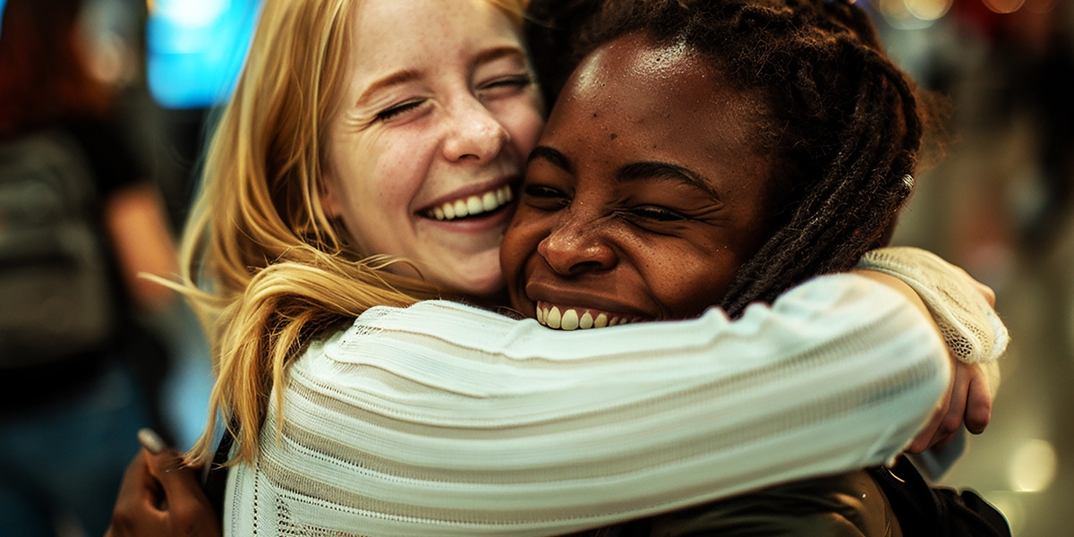 two racially diverse woman hugging