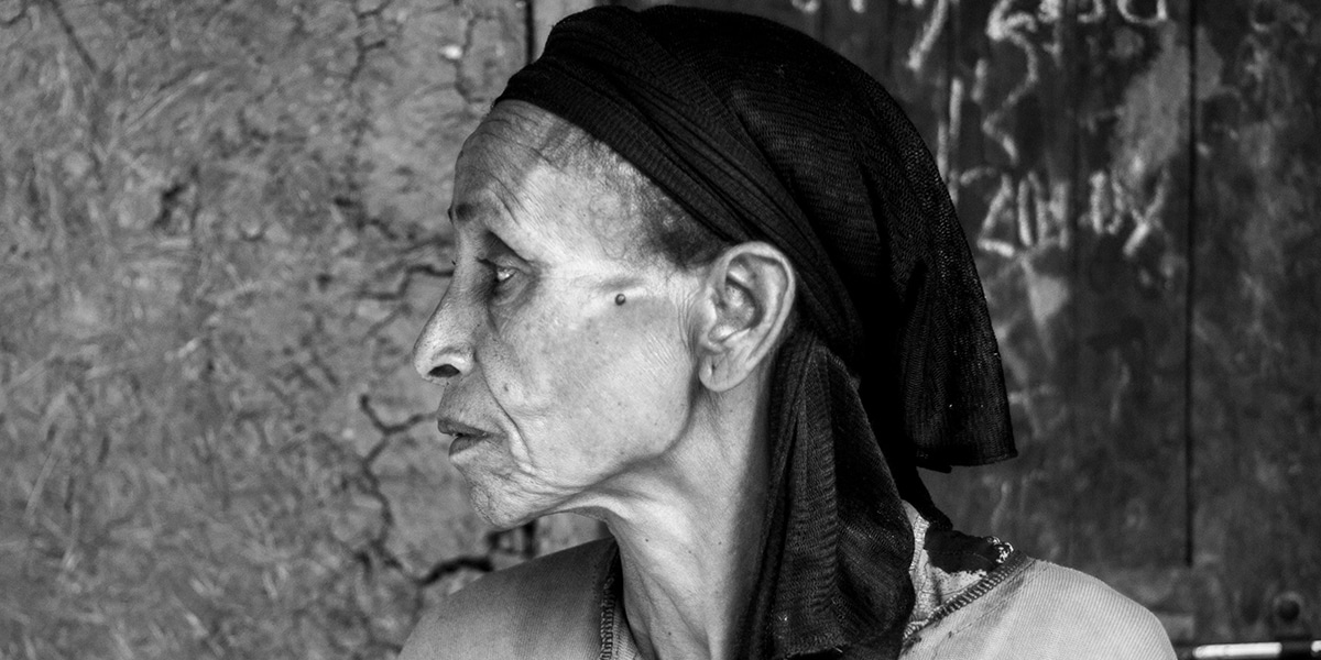 a woman living in poverty wearing a headscarf