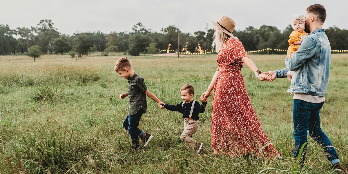 family walking through a field.