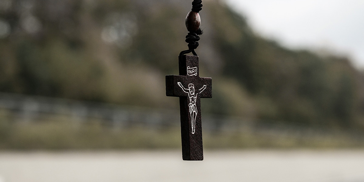 Small crucifix with Jesus hanging from a car mirror