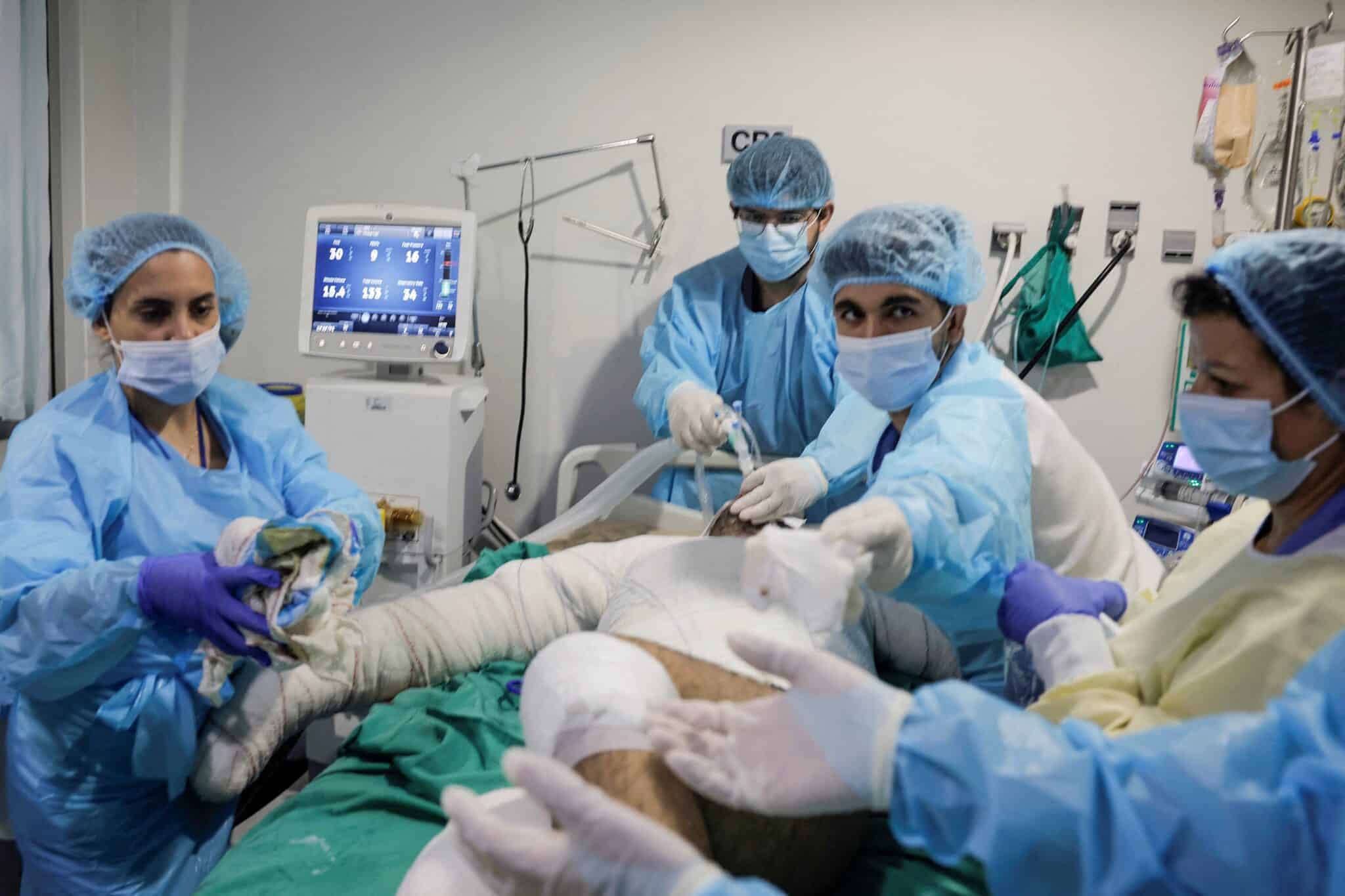 a group of people in scrubs and masks performing an operation