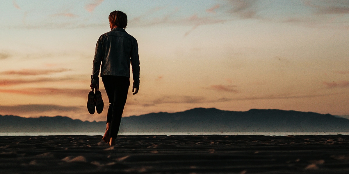 person walking along a beach