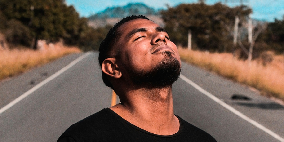 A confident person holding his head up with a grateful posture.