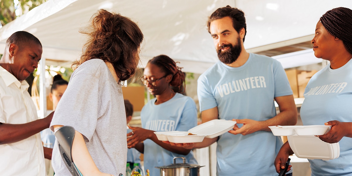 volunteers helping at a food bank serving meals