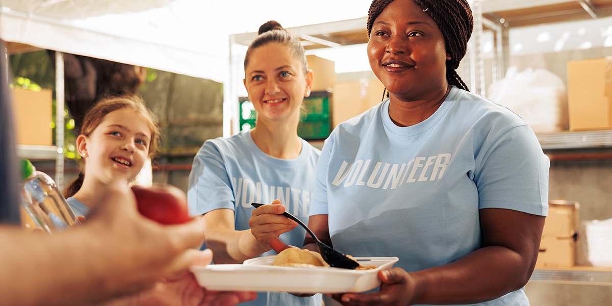 Volunteers handing out food to the poor