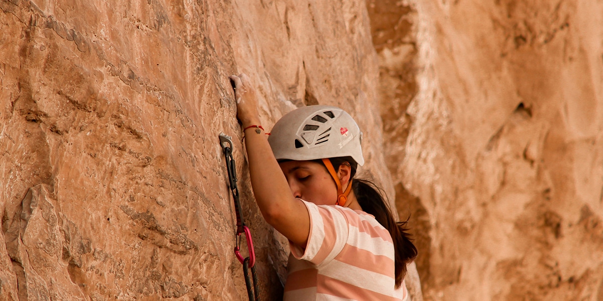 woman courageously rock climbing