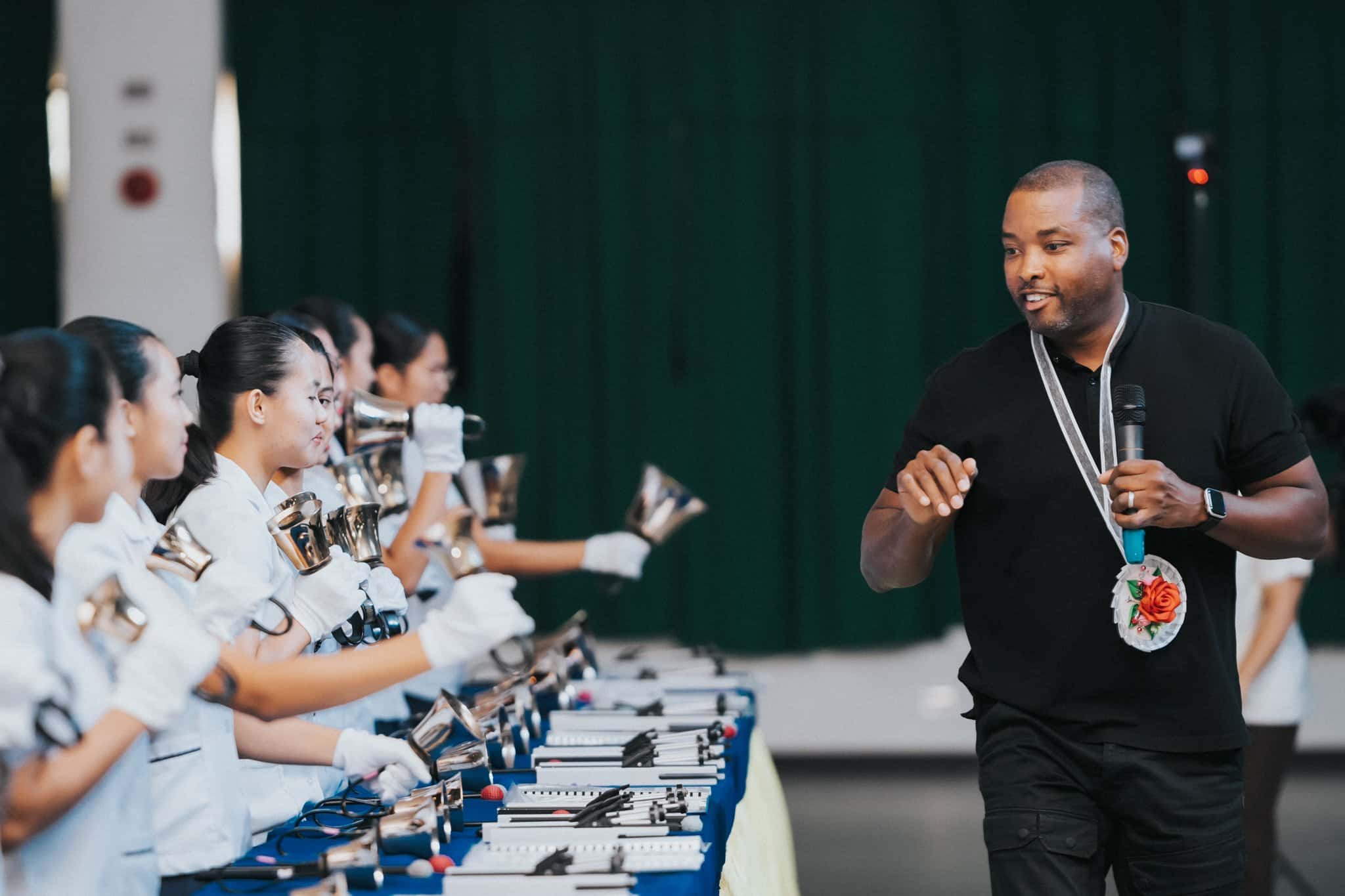 Black Eyed Peas drummer and producer Keith Harris is pictured in an undated photo talking to the handbell choir and choral singers of Sisters of Mary Schools in the Philippines during a recording of a new Christmas song "It's That Time Of Year" written by Harris, fellow bandmate Filipino-American Apl.de.Ap and David "DQ" Quiñones.