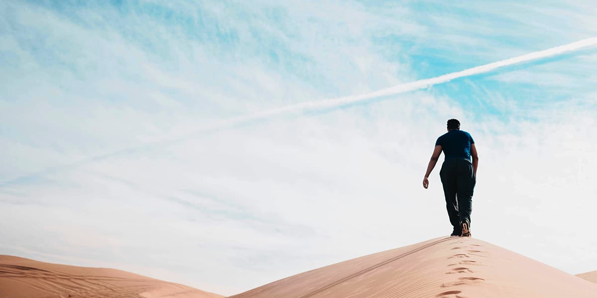 Man walking in the desert.