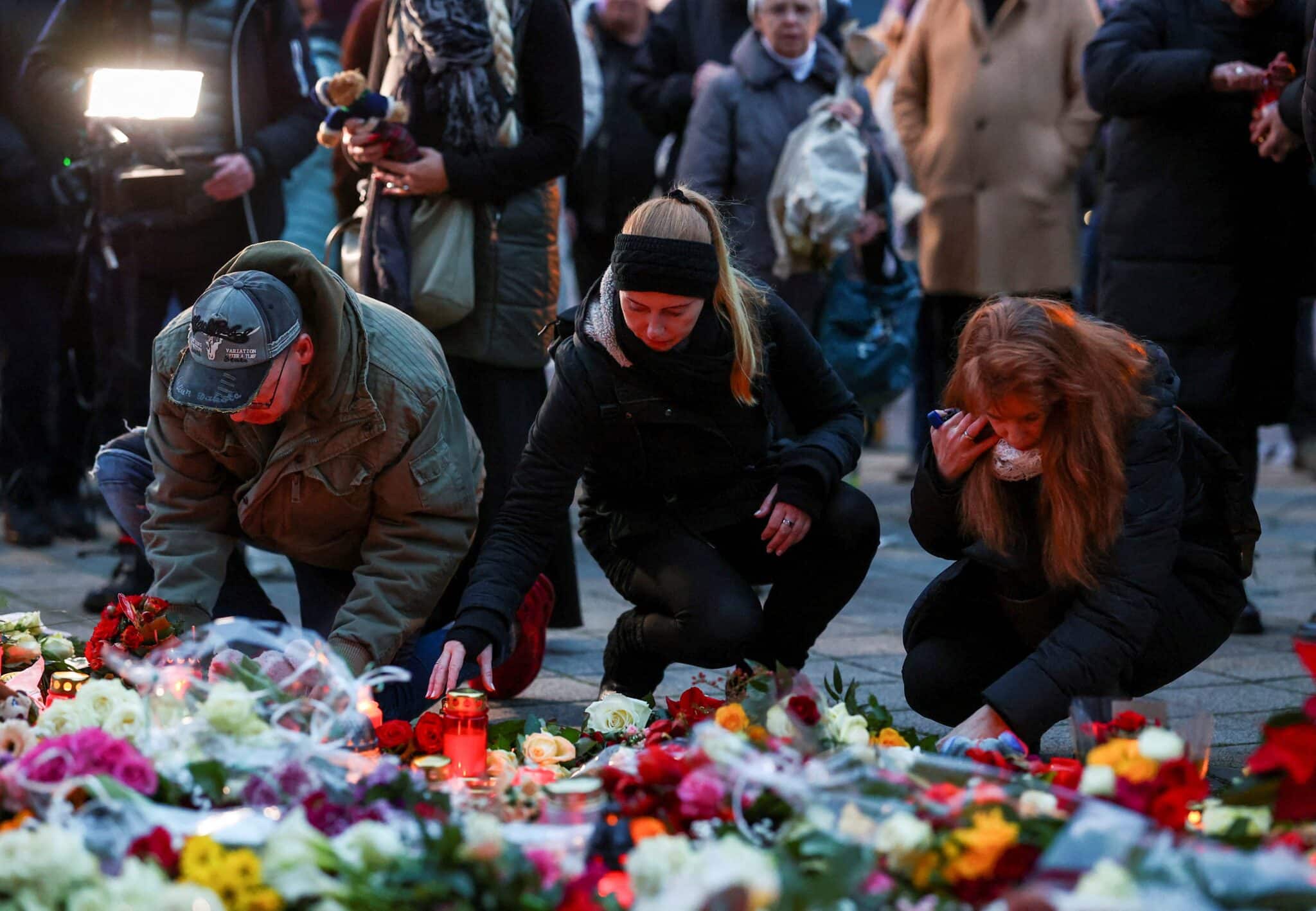 People lay candles and tributes Dec. 21, 2024, at the site where a car drove into a crowd at a Magdeburg Christmas market in Magdeburg, Germany.