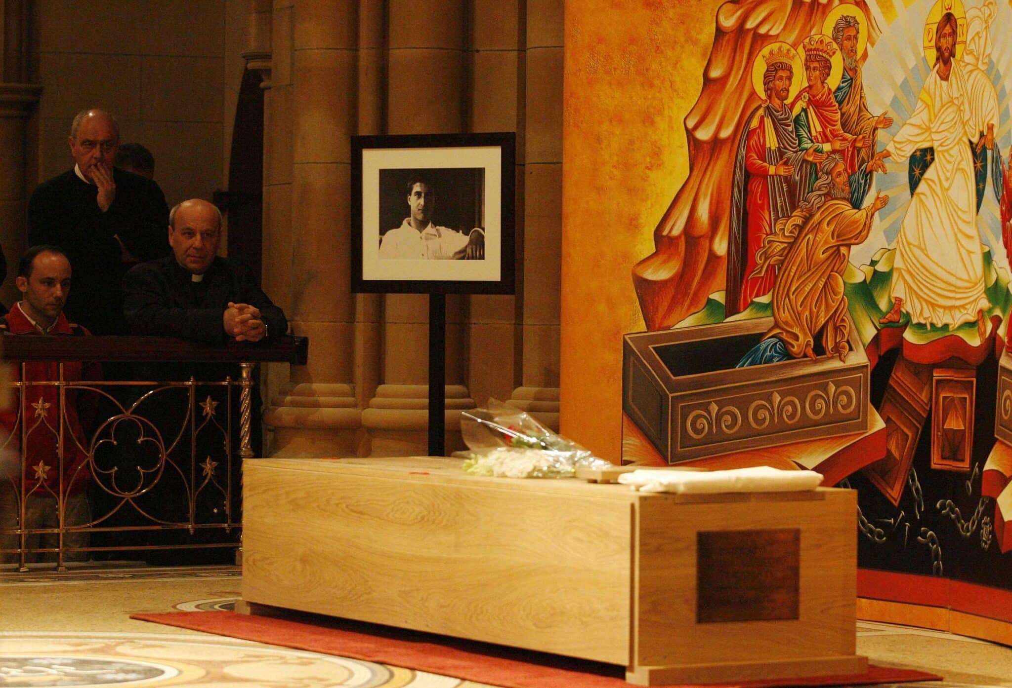 Pilgrims pray next to the coffin of Blessed Pier Giorgio Frassati at St. Mary's Cathedral in Sydney, Australia, July 10. Blessed Pier Giorgio died at age 24 in 1925 and was beatified by Pope John Paul II in 1990. (CNS photo/Daniel Munoz, Reuters)